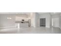 Open concept living space with ceramic tile flooring, soaring ceilings, and abundant natural light at 35 Peterlee Ct, Kissimmee, FL 34758