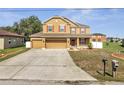 Well-maintained home with a spacious three-car garage and manicured front yard at 355 Churchill Ct, Kissimmee, FL 34759