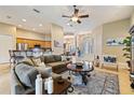 Spacious living room with a large sofa, decorative rug, and an open floor plan with views into the kitchen and dining areas at 3856 Shoreside Dr, Kissimmee, FL 34746