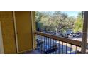 Balcony view overlooking a parking lot with lush trees and greenery at 5287 Images Cir # 307, Kissimmee, FL 34746
