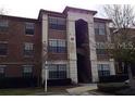 Multi-story condo building with neutral tones and well-maintained landscaping at 6137 Metrowest Blvd # 308, Orlando, FL 32835