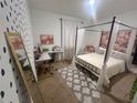 Stylized bedroom featuring a four-poster bed, desk, and patterned wallpaper, ideal for relaxation and study at 820 Cambridge Dr, Winter Haven, FL 33881