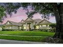 Stunning home with a landscaped lawn and elegant exterior design at 8214 Lake Serene Dr, Orlando, FL 32836