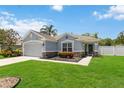 Charming single Gathering home with a well-manicured lawn, beautiful landscaping and a two car garage at 832 Seneca Trl, St Cloud, FL 34772