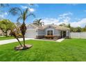 Charming single Gathering home with a well-manicured lawn, beautiful landscaping and a palm tree at 832 Seneca Trl, St Cloud, FL 34772