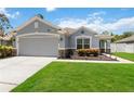 Charming single Gathering home with a well-manicured lawn and beautiful landscaping during daytime at 832 Seneca Trl, St Cloud, FL 34772