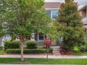 Beautiful two-story home featuring lush landscaping and a welcoming front porch, perfect for enjoying the outdoors at 8359 Lookout Pointe Dr, Windermere, FL 34786