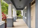Spacious front porch with elegant columns, offering a welcoming and shaded entrance to the home at 8359 Lookout Pointe Dr, Windermere, FL 34786
