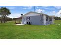Home exterior showcasing a large yard and back patio perfect for outdoor living at 1 Coyer Rd, Haines City, FL 33844