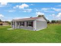 Well-maintained home with a spacious lawn, showcasing a clean exterior and tidy landscaping at 1 Coyer Rd, Haines City, FL 33844