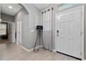 Bright entryway with light tile flooring, arched doorways, and a white front door and interior doors at 11051 Bostwick Aly, Winter Garden, FL 34787