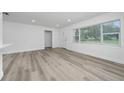 Bright living room with large window and new vinyl flooring provides a cozy atmosphere at 113 W Division St, Winter Garden, FL 34787
