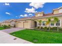 Well-maintained home with a two-car garage, tile roof, and lush green lawn at 1173 Trappers Trail Loop, Champions Gate, FL 33896