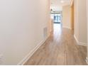 Inviting hallway with tile flooring, neutral walls, and ample natural light at 1173 Trappers Trail Loop, Champions Gate, FL 33896