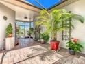 Enclosed patio with brick floors, potted plants, and trellis accents at 125 Prima Dr, Poinciana, FL 34759