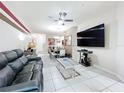 Inviting living room boasts a ceiling fan, tile flooring, and a comfortable leather sofa at 14234 Desert Haven St # 14234, Windermere, FL 34786