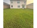 Spacious backyard with a large grass lawn, perfect for outdoor activities and entertaining at 1591 Barberry Dr, Kissimmee, FL 34744