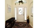 Welcoming foyer featuring a bench seat and neutral decor with a decorative wreath on the front door at 2591 Oneida Loop, Kissimmee, FL 34747