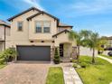 Charming home with a two-car garage, inviting entrance, and well-maintained landscaping at 2824 Noble Crow Dr, Kissimmee, FL 34744
