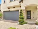 Inviting entryway with stone accents, neat shrubbery, and a modern front door at 2824 Noble Crow Dr, Kissimmee, FL 34744