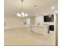 Open-concept living room with tile floors, natural light, and a view of the kitchen at 2833 Noble Crow Dr, Kissimmee, FL 34744