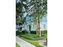 Inviting two-story home featuring blue and white exterior, manicured landscaping, and charming front entrance at 2862 Grasmere View Pkwy, Kissimmee, FL 34746