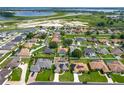 Expansive aerial shot highlighting the well-planned community and its proximity to a picturesque lake at 301 Terranova Blvd, Winter Haven, FL 33884