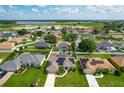Desirable community featuring well-maintained houses and lush green lawns, conveniently located near a scenic lake at 301 Terranova Blvd, Winter Haven, FL 33884