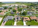 Well-maintained community with houses and green lawns in a peaceful location with lake views at 301 Terranova Blvd, Winter Haven, FL 33884
