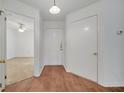Bright entryway boasts wood floors, white door, and a glimpse into the adjacent room at 3205 Sabal Palms Ct # A, Kissimmee, FL 34747