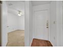 Hallway with wood floors leading to a room with carpet and a ceiling fan at 3205 Sabal Palms Ct # A, Kissimmee, FL 34747