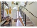 Inviting entryway featuring tile floors, staircase with wrought iron railing, and decorative accents at 344 Cherokee Ave, Haines City, FL 33844