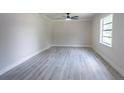 Bright living room featuring modern vinyl flooring, ceiling fan, neutral paint, and plenty of natural light at 3524 Hage Way, Orlando, FL 32805