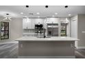 Bright, updated kitchen with an island, stainless steel appliances, and contemporary lighting at 3623 Tree Line Way, St Cloud, FL 34769