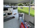 Large backyard with a covered patio and outdoor seating, perfect for relaxation at 400 Vermont Ave, St Cloud, FL 34769