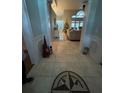 Inviting foyer with tile flooring, decorative inlays, and view into the living space at 4820 Wingrove Blvd, Orlando, FL 32819
