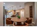 Cozy dining area with warm tones, modern lighting, and views of the kitchen, perfect for intimate gatherings at 5573 Torino Rd, Kissimmee, FL 34746