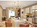 Modern kitchen with sleek island, stainless steel appliances, and pendant lighting offers style and functionality at 5573 Torino Rd, Kissimmee, FL 34746