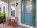 Inviting front porch featuring seating, a stylish front door, and address numbers at 7266 Desert Mandarin St, Winter Garden, FL 34787