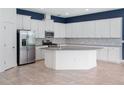 Spacious kitchen with ample cabinet space, stainless steel appliances, and center island at 7266 Desert Mandarin St, Winter Garden, FL 34787