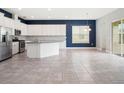 Modern kitchen with granite countertops, stainless steel appliances, and tile flooring at 7266 Desert Mandarin St, Winter Garden, FL 34787