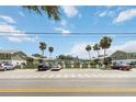 Exterior of two-story condos with palm trees and a parking lot; unit parking available at 840 Center Ave # 80, Daytona Beach, FL 32117