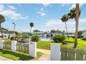 Community pool area with fence, landscaping, and nearby two-story condo buildings at 840 Center Ave # 80, Daytona Beach, FL 32117