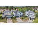 Aerial view of a lovely two-story home with a well-manicured lawn in a residential neighborhood at 11603 Malverns Loop, Orlando, FL 32832
