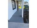 A side porch view highlighting the painted concrete flooring and support columns at 124 Cinnamon Dr, Orlando, FL 32825