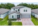 Charming two-story home with light-blue shutters, attached garage, and well-manicured lawn at 1538 Mermaid Way, Haines City, FL 33844
