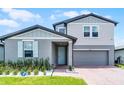 Charming two-story home with light-blue shutters, attached garage, and well-manicured lawn at 1538 Mermaid Way, Haines City, FL 33844