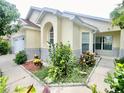 Exterior view of a well-maintained one-story home showcasing landscaping and architectural details at 162 Seneca Point Trl, Kissimmee, FL 34746
