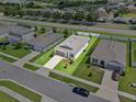 High-angle aerial view of a single-Gathering home featuring a manicured lawn and surrounding streets at 1717 Hilltop Dr, Dundee, FL 33838