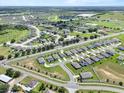Expansive aerial view of a residential community with single-Gathering homes and green spaces at 1717 Hilltop Dr, Dundee, FL 33838